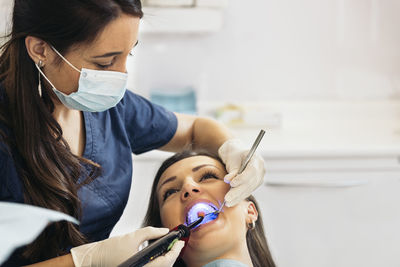 Dentist examining woman