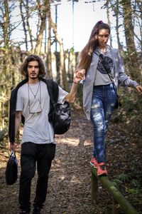 Portrait of smiling young woman walking in forest