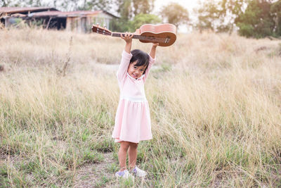 Full length of girl standing on field