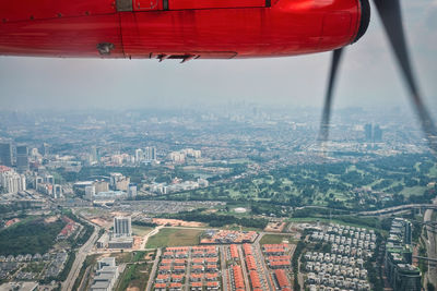 Cropped image of airplane flying over city