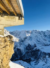 Scenic view of snowcapped mountains against clear blue sky