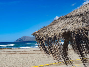 Scenic view of beach against blue sky