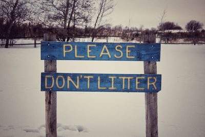 Information sign on snow covered land