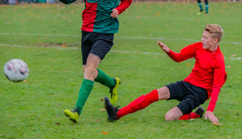 People playing soccer on field