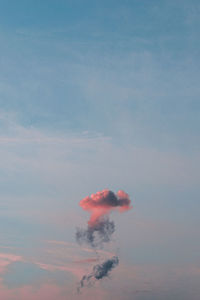 Low angle view of smoke emitting from chimney against sky