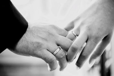Cropped image of couple hands with wedding rings