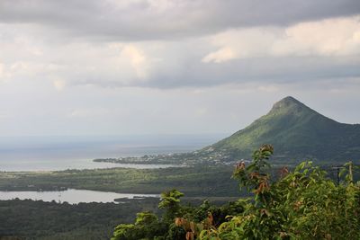 Scenic view of sea and mountains against sky