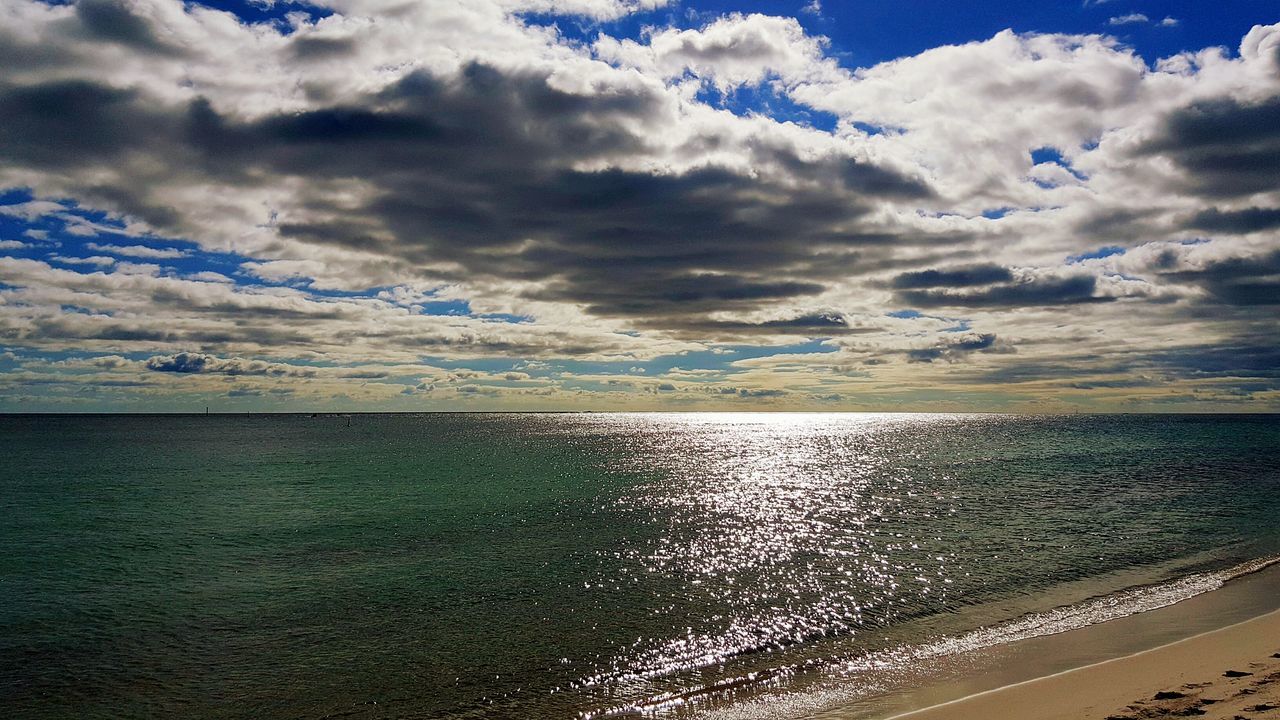 VIEW OF CALM SEA AGAINST CLOUDS