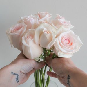 Close-up of hand holding rose bouquet