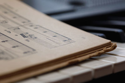 Close up of sheet music on the piano keys