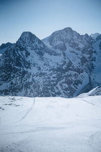 Scenic view of snowcapped mountains against clear sky