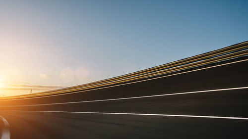 View of road against clear sky during sunset