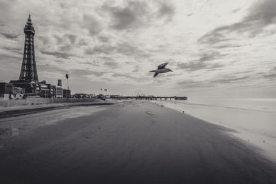 Scenic view of beach against cloudy sky