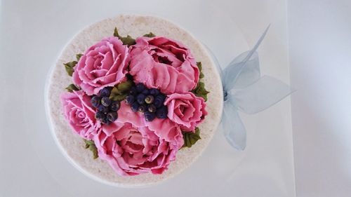 Directly above shot of wedding cake on white table