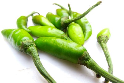 Close-up of green chili pepper against white background