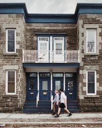Full length of people on building