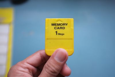 Close-up of hand holding yellow sign