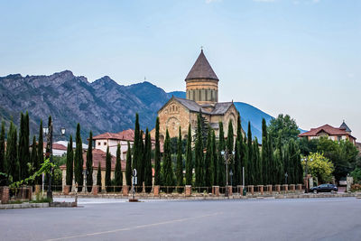 Panoramic view of trees and building against sky