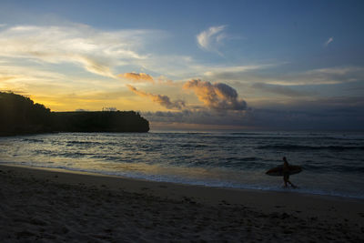 Scenic view of beach against sky during sunset