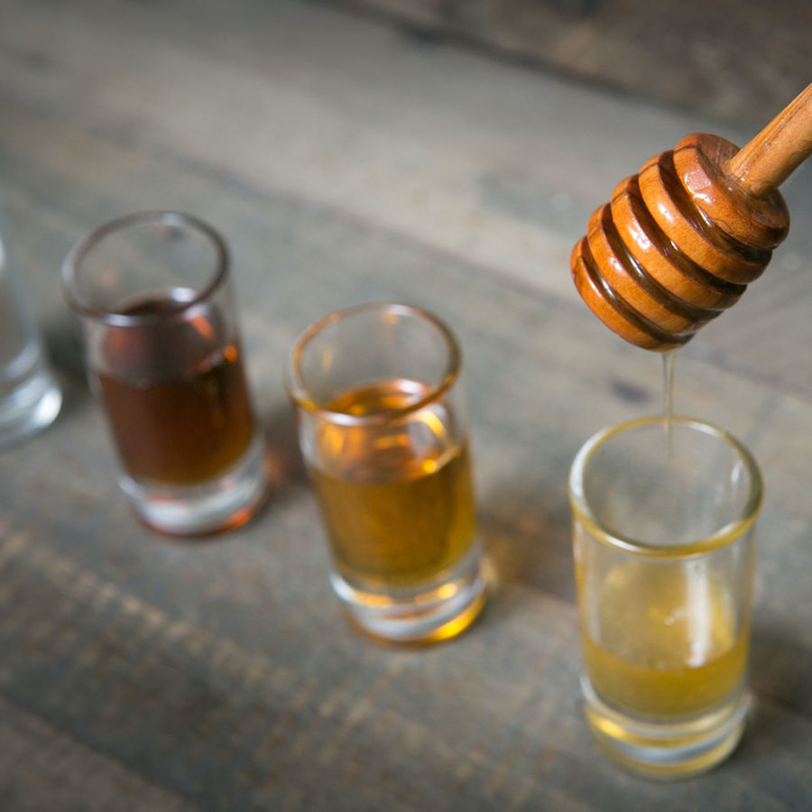 CLOSE-UP OF BEER GLASS ON TABLE