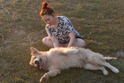 Full length of man with dog on field