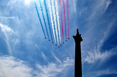 Low angle view of vapor trails against sky