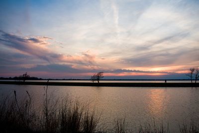 Scenic view of river against sky during sunset