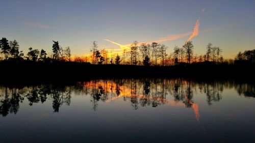 Scenic view of lake at sunset