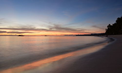 Scenic view of beach against sky during sunset