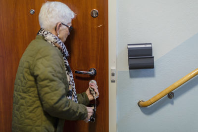 Woman closing entrance door