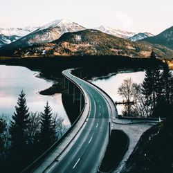 Scenic view of lake by mountains against sky