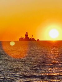 Scenic view of sea against orange sky