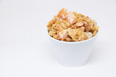 Close-up of pasta in bowl against white background