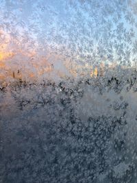 Full frame shot of sky seen through window during winter