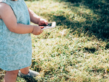 Woman using mobile phone in field