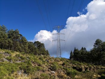 Low angle view of electricity pylon against sky