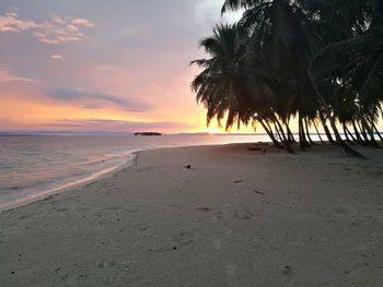 Scenic view of beach against sky during sunset