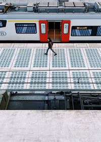 Woman standing by window in city