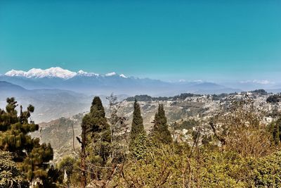 Scenic view of mountains against blue sky in darjeeling / india 