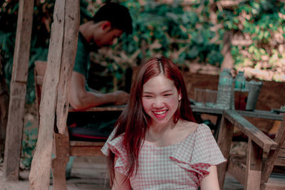 Smiling woman and man sitting at table 