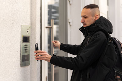 Side view of man using mobile phone