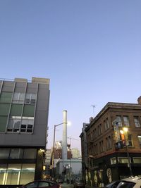 Low angle view of illuminated buildings against clear sky