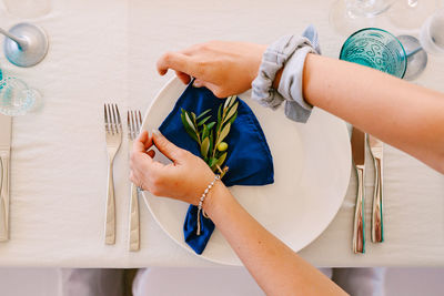 High angle view of people on white table