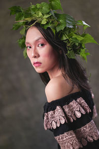 Portrait of woman standing against plants