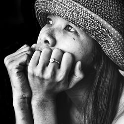 Close-up portrait of woman wearing hat