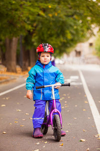 Portrait of boy riding motorcycle on road