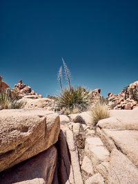 Rock formations in desert against clear blue sky