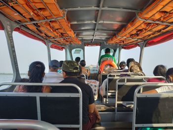 Rear view of people sitting in bus