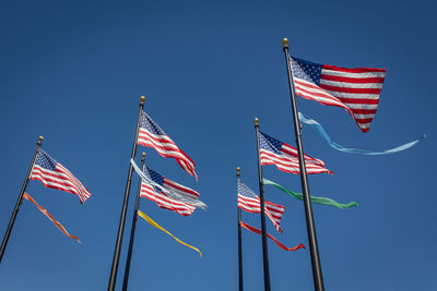 Low angle view of flag against blue sky