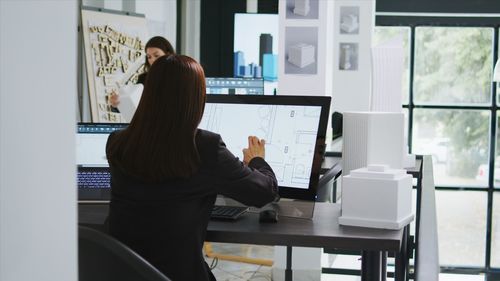 Side view of man working at office